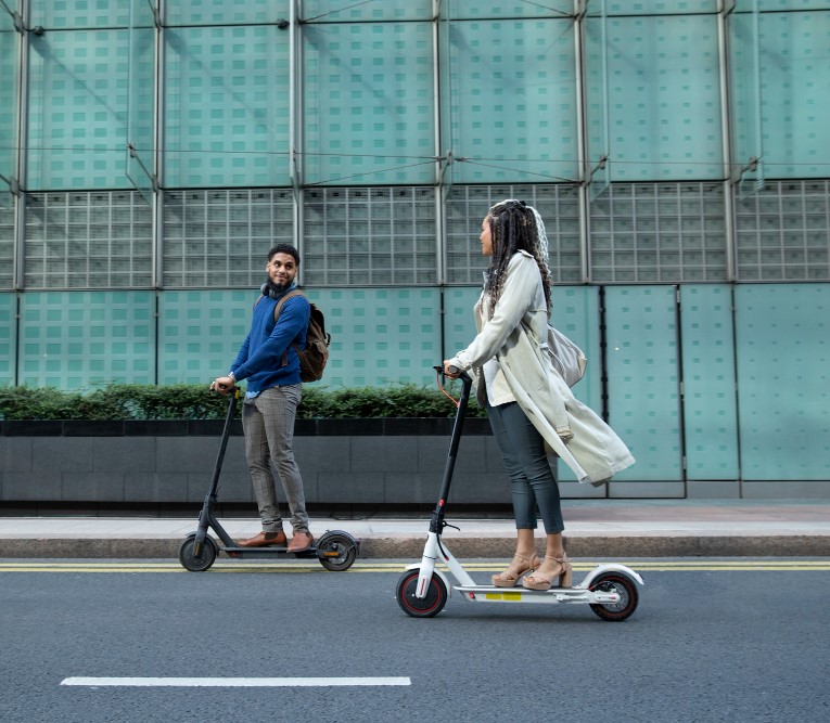 two persons e kick scoot